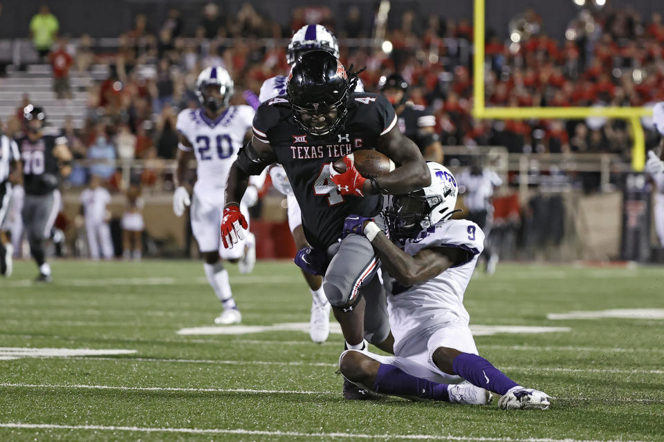 TCU's C.J. Ceasar II (9) tackles Texas Tech's SaRodorick Thompson (4) during the second half of an NCAA college football game Saturday, Oct. 9, 2021, in Lubbock, Texas. (AP Photo/Brad Tollefson)