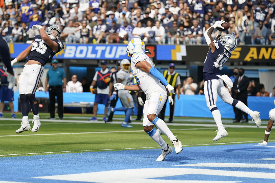 Dallas Cowboys strong safety Damontae Kazee, right, intercepts a pass against the Los Angeles Chargers during the second half of an NFL football game Sunday, Sept. 19, 2021, in Inglewood, Calif. (AP Photo/Gregory Bull)