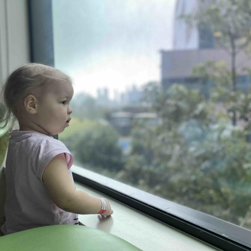 Chloé stares out of her hospital window. Her hair has begun to fall out after chemotherapy. Source: supplied