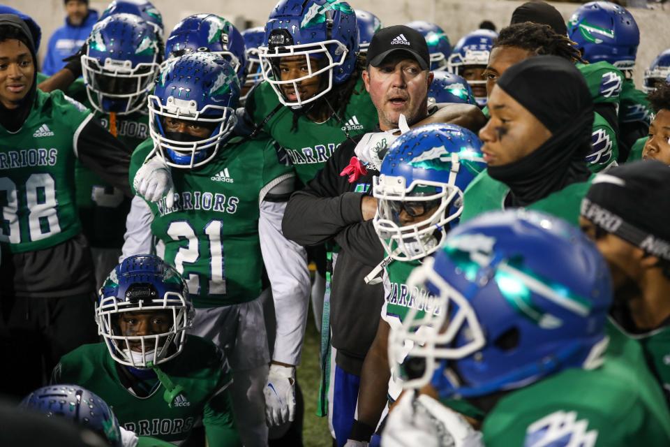 The Cincinnati Winton Woods Warriors gather before the OHSAA Division II State game against The Akron Archbishop Hoban Knights at the Tom Benson Hall of Fame stadium. The Warriors lead the game at halftime with a score of 14-3.