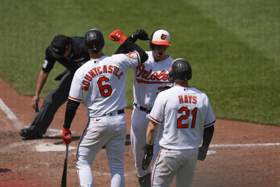 Baltimore Orioles designated hitter Adley Rutschman, center, celebrates with Ryan Mountcastle (6) and Austin Hays (21) during the seventh inning of a baseball game at Oriole Park at Camden Yards, Thursday, May 18, 2023, in Baltimore. (AP Photo/Jess Rapfogel)