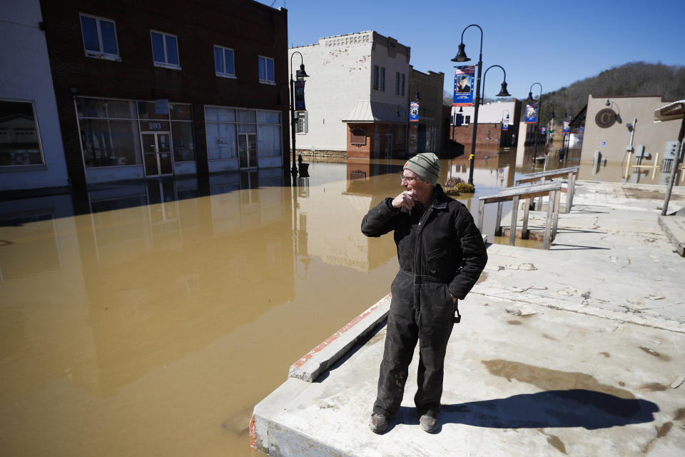 Phillip Lucas, of Beattyville, Ky., overlooks a flooded Main Street after heavy rains caused the Kentucky River to flood most of downtown Beattyville, Ky., Tuesday, March 2, 2021. Lucas owns a building along Main Street and was preparing to assess the damage. (Alex Slitz/Lexington Herald-Leader via AP)