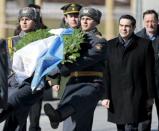 Greek Prime Minister Alexis Tsipras (R) takes part in a wreath laying ceremony at the Tomb of the Unknown Soldier by the Kremlin walls in central Moscow, April 8, 2015. REUTERS/Ivan Sekretarev