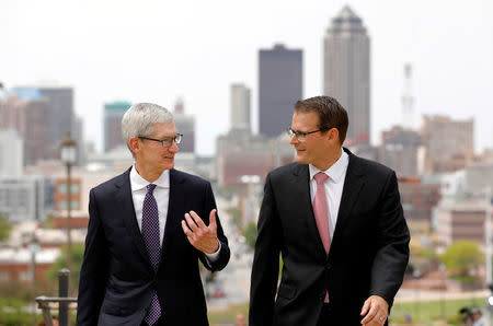 Apple Chief Executive Officer Tim Cook (L) walks with Iowa Lt. Governor Adam Gregg after announcing Apple plans to build a $1.375 billion data center in Waukee, Iowa, at the Iowa State Capitol in Des Moines, Iowa August 24, 2017. REUTERS/Scott Morgan