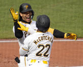 Pittsburgh Pirates' Connor Joe, left, celebrates with Andrew McCutchen (22) after hitting a three-run home run off Chicago Cubs starting pitcher Justin Steele during the third inning of a baseball game in Pittsburgh, Saturday, May 11, 2024. (AP Photo/Gene J. Puskar)