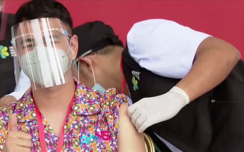 Indonesian influencer Raffi Ahmad gestures while receiving a shot of the coronavirus disease (COVID-19) vaccine at the Merdeka Palace in Jakarta