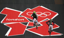 LONDON, ENGLAND - AUGUST 07: Squel Stein of Brazil (L) and Brooke Crain of the United States train on the BMX track in Olympic Park on Day 11 of the London 2012 Olympic Games on August 7, 2012 in London, England. (Photo by Phil Walter/Getty Images)