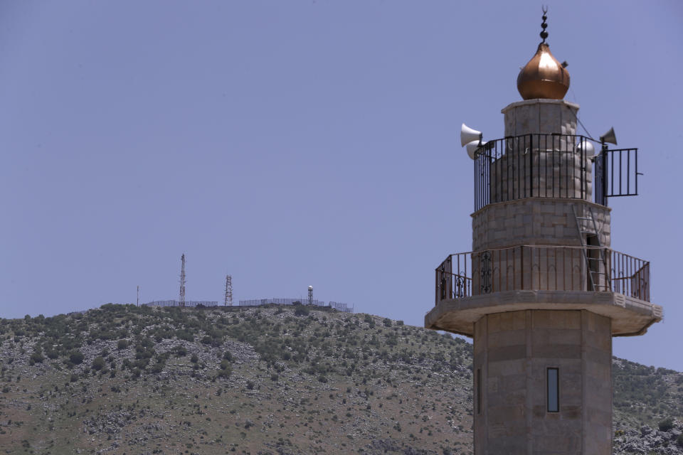 An Israeli military position on a hill on the top of Mount Hermon in the Israeli-controlled Golan Heights is seen from Kfar Chouba village, where the borders between Israel, Syria and Lebanon meet, in southeast Lebanon, Wednesday, May 20, 2020. Twenty years after Hezbollah guerrillas pushed Israel’s last troops from southern Lebanon, both sides are gearing up for what could be another war, one that neither seems to want. (AP Photo/Bilal Hussein)