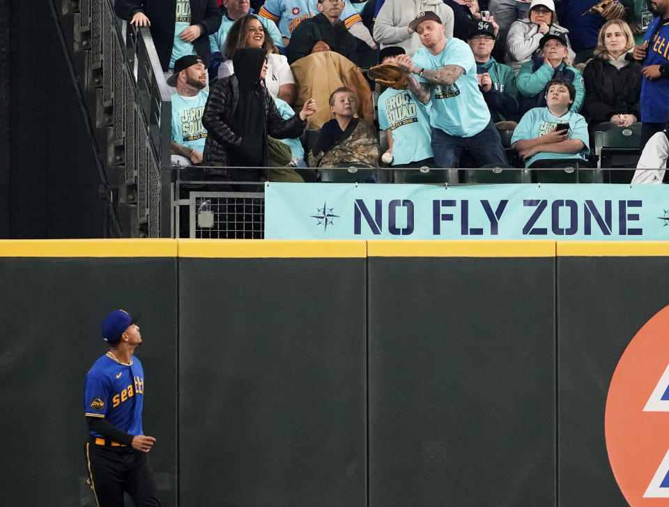 Seattle Mariners center fielder Julio Rodriguez, bottom left, watches as a home run by Houston Astros' Yordan Alvarez goes over the fence during the third inning of a baseball game Friday, May 5, 2023, in Seattle. (AP Photo/Lindsey Wasson)