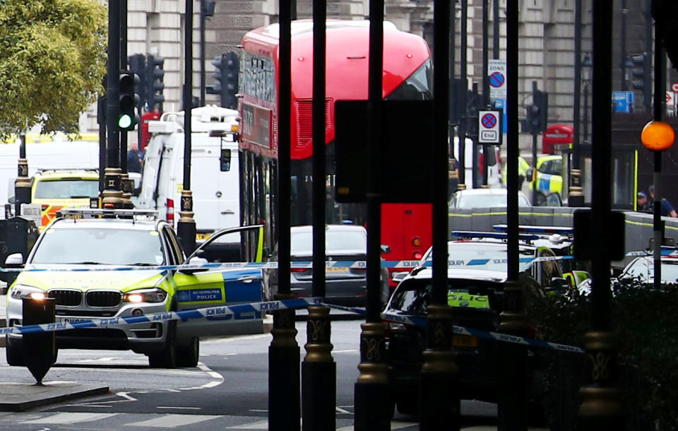 A car that crashed outside the Houses of Parliament is surrounded by members of the emergency services in Westminster, London, Britain, August 14, 2018. REUTERS/Hannah McKay