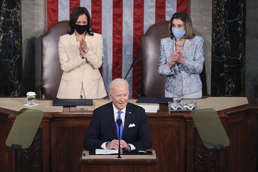 President Biden is joined by Vice President Kamala Harris, left, and Nancy Pelosi as addresses a joint session of Congress.