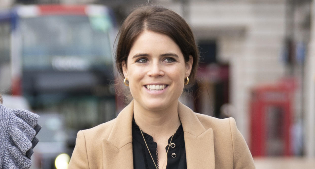 A close up image of Princess Eugenie wearing a camel coloured coat and hair in a bun. (Getty Images)