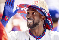 Philadelphia Phillies' Andrew McCutchen celebrates in the dugout after hitting a grand slam home run during the fifth inning of a baseball game against the Washington Nationals, Wednesday, June 23, 2021, in Philadelphia. (AP Photo/Laurence Kesterson)