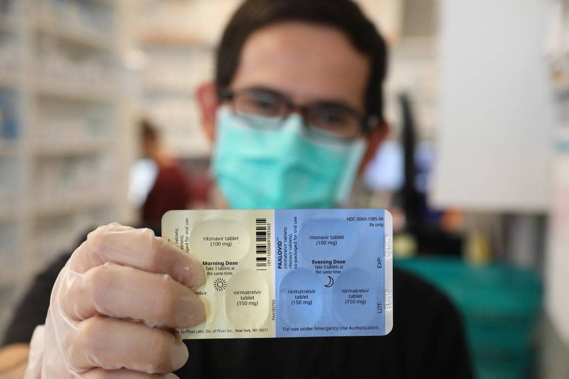 SureCare Pharmacy manager Oscar Uribe shows off a package of Pfizer Paxlovid pills inside of Esperanza Health Center in Chicago’s Brighton Park neighborhood on Thursday, Jan. 13, 2022. Pfizer’s Paxlovid is a treatment for COVID-19.