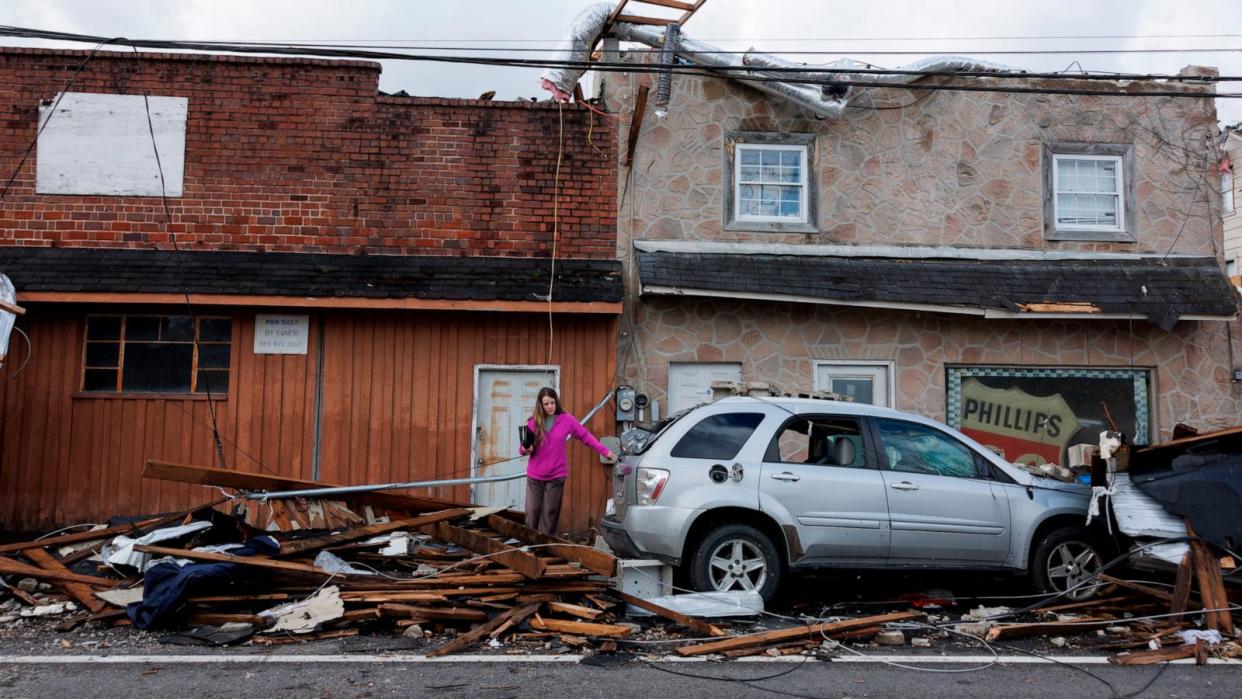 PHOTO: A woman exits a tornado damaged building on April 3, 2024 in Sunbright, Tenn. (Brett Carlsen/Getty Images, FILE)