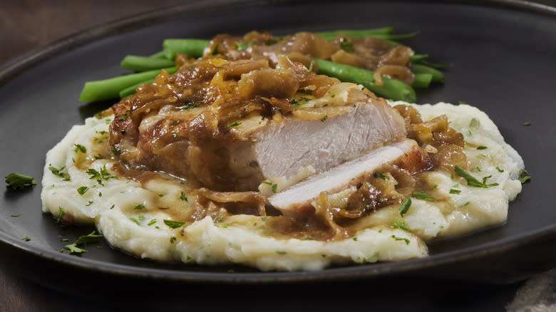 Pork chop with caramelized onions on mash