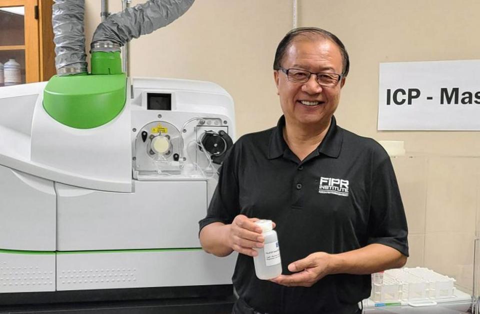 Dr. Patrick Zhang, research director of phosphate beneficiation and mining at the Florida Industrial and Phosphate Research Institute, part of Florida Polytechnic University, shows a solution containing rare earth minerals in the institute’s lab.