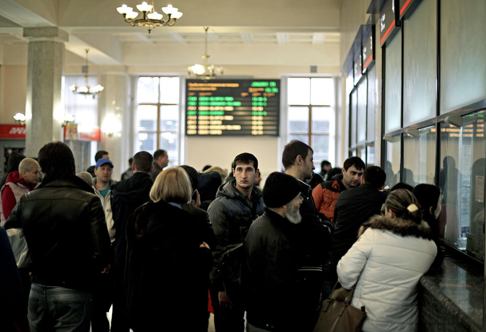 People line up at a ticket window in the central train station, Wednesday, Jan. 29, 2014, in Sochi, Russia, home of the upcoming 2014 Winter Olympics. (AP Photo/David Goldman)