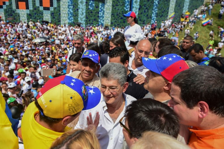 Opposition leader Henrique Capriles (L) and the president of the National Assembly, Henry Ramos Allup (C), attend a demonstration against the government of Venezuelan President Nicolas Maduro in Caracas