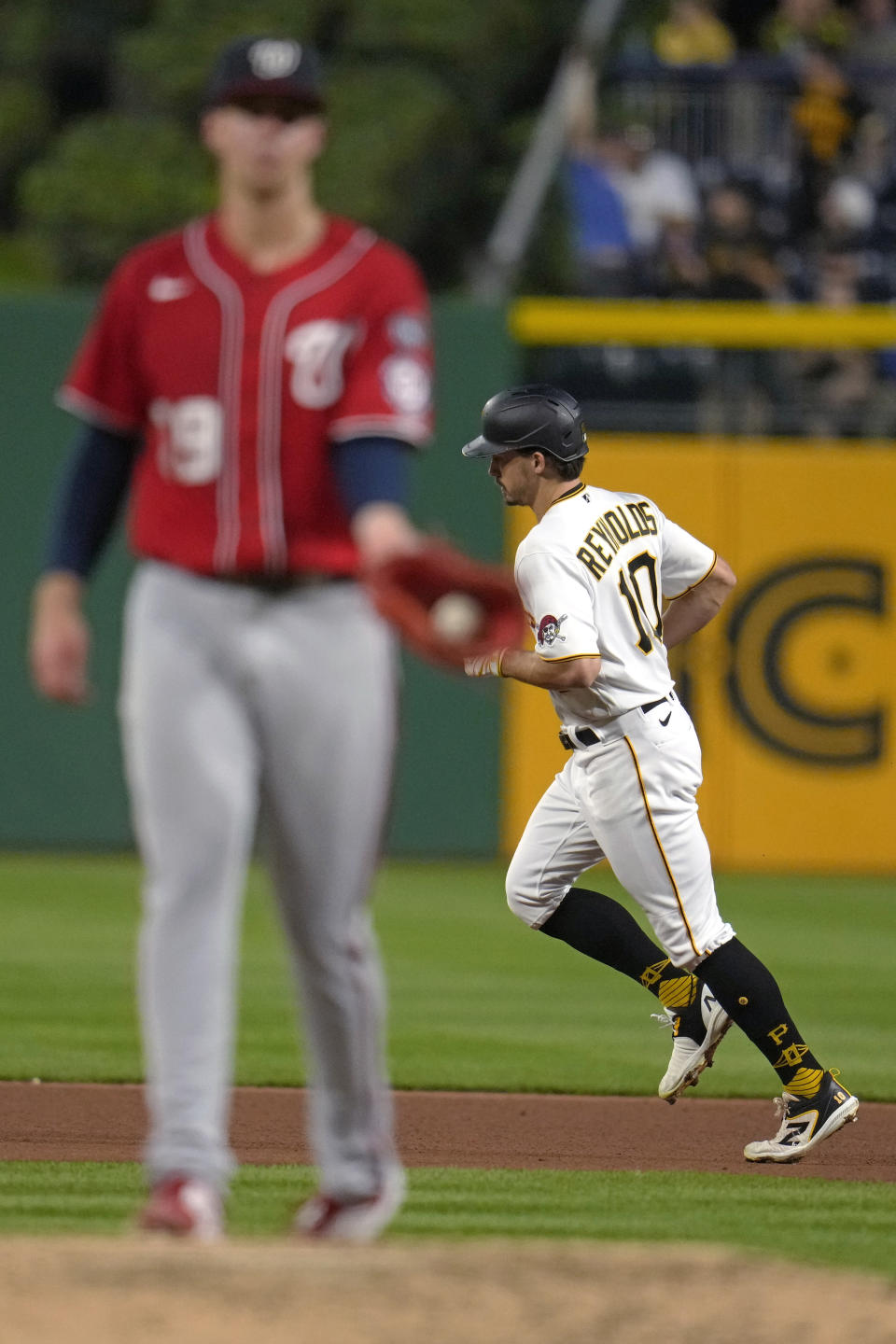 Pittsburgh Pirates' Bryan Reynolds runs the bases on a two-run home run off Washington Nationals starting pitcher Jackson Rutledge, left, during the fourth inning of a baseball game in Pittsburgh, Wednesday, Sept. 13, 2023. (AP Photo/Gene J. Puskar)
