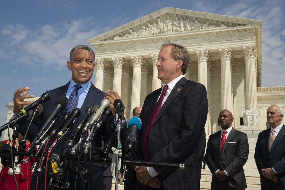 District of Columbia Attorney General Karl Racine, with Texas Attorney General Ken Paxton, right, and a bipartisan group of state attorneys general speaks to reporters in front of the U.S. Supreme Court in Washington, Monday, Sept. 9, 2019 on an antitrust investigation of big tech companies. (AP Photo/Manuel Balce Ceneta)