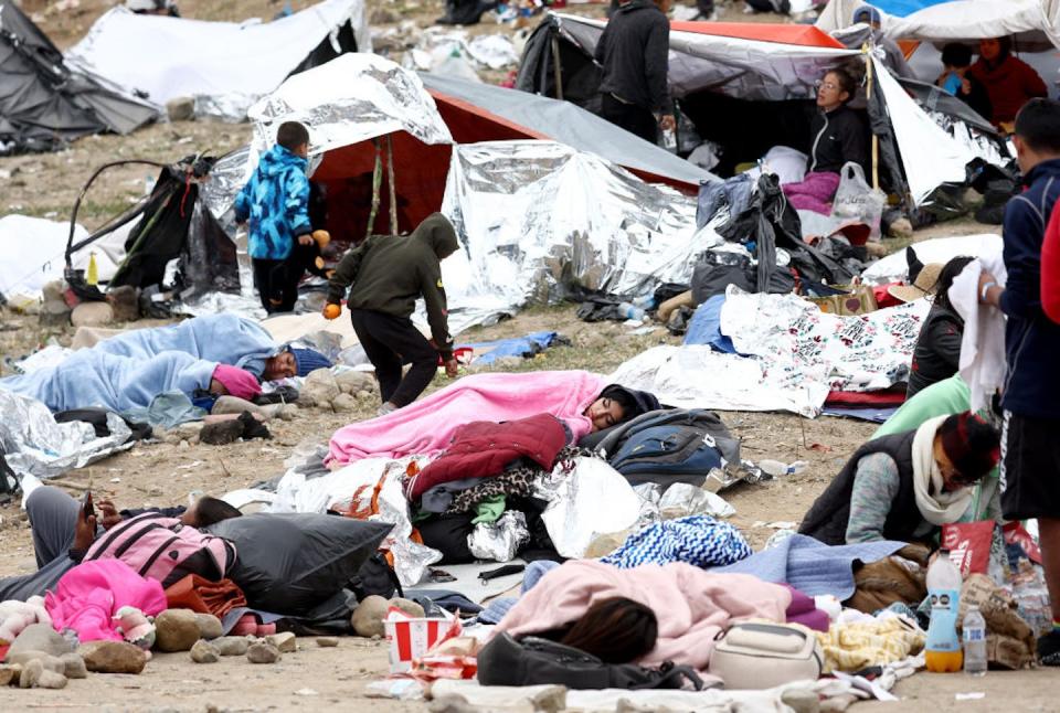 Immigrants gather at a makeshift camp near the border between the U.S. and Mexico on May 13, 2023. <a href="https://www.gettyimages.com/detail/news-photo/immigrants-gather-at-a-makeshift-camp-stranded-amongst-news-photo/1490419828?adppopup=true" rel="nofollow noopener" target="_blank" data-ylk="slk:Mario Tama/Getty Images;elm:context_link;itc:0;sec:content-canvas" class="link ">Mario Tama/Getty Images</a>