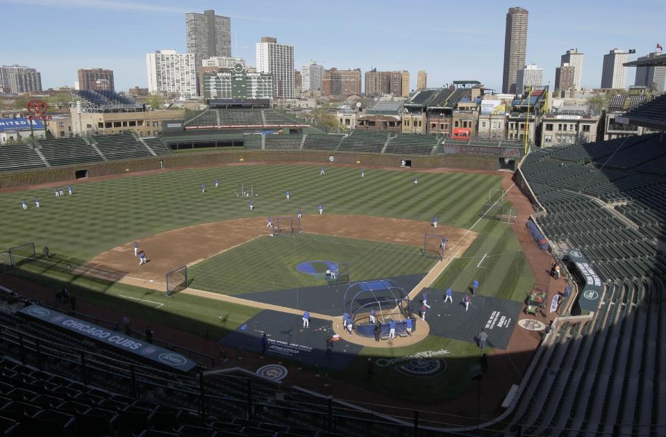 FILE - In this April 4, 2012, file photo, Chicago Cubs players work out at Wrigley Field in Chicago, the day before their opening day baseball game against the Washington Nationals. Chicago’s Wrigley Field, New Orleans’ Saenger Theatre and a historic Los Angeles’ shipbuilding center have joined a list of sites being saved thanks to the efforts of historic preservationists in 2013. (AP Photo/Nam Y. Huh, File)