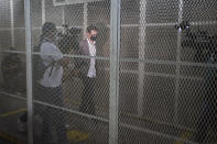 The son of former Panamanian President Ricardo Martinelli, Luis Enrique Martinelli Linares, is escorted by an officer to a hearing at the judicial court building in Guatemala City, Tuesday, July 7, 2020. Luis Enrique and his brother Ricardo were detained on Monday on an international warrant from Interpol on charges of conspiracy to commit money laundering. (AP Photo/Moises Castillo)