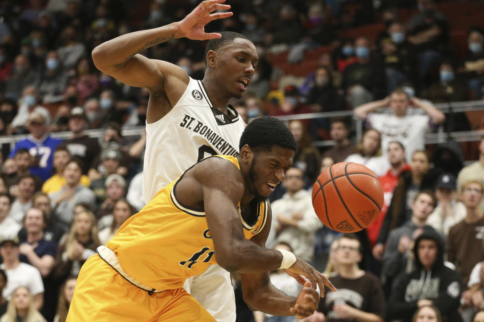 Canisius guard Armon Harried (11) loses the ball as he's fouled by St. Bonaventure guard Kyle Lofton (0) during the first half of an NCAA college basketball game Sunday, Nov. 14, 2021, in Olean, N.Y. (AP Photo/Joshua Bessex)