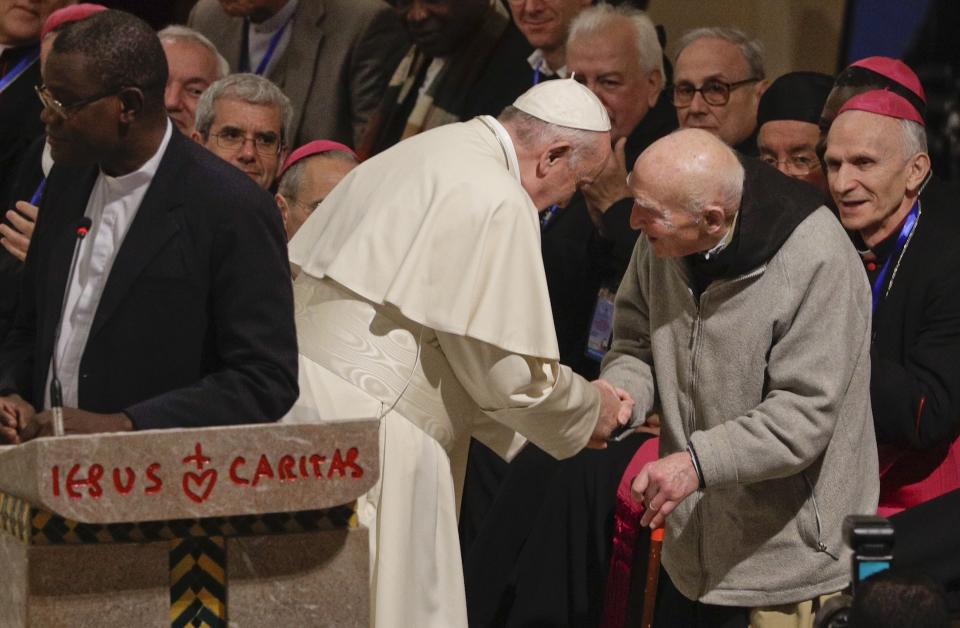 Pope Francis greets father Jean-Pierre Schumacher, a French monk who survived the Tibhirine killing, when seven Trappist monks and 12 other Catholics were kidnapped from the monastery of Tibhirine, south of Algiers in 1996 and killed, in the Rabat Cathedral, Morocco, Sunday, March 31, 2019. Pope Francis is in Morocco for a two-day trip aimed at highlighting the North African nation's Christian-Muslim ties, while also showing solidarity with migrants at Europe's door and tending to a tiny Catholic flock. (AP Photo/Gregorio Borgia)