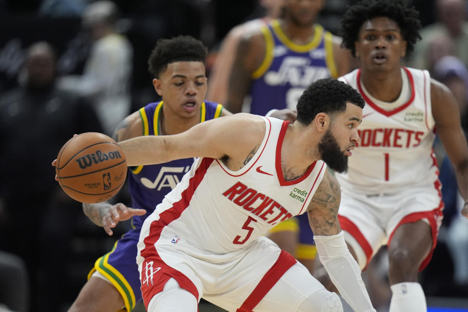 Houston Rockets guard Fred VanVleet (5) drives as Utah Jazz guard Keyonte George, left, defends during the first half of an NBA basketball game Thursday, April 11, 2024, in Salt Lake City. (AP Photo/Rick Bowmer)