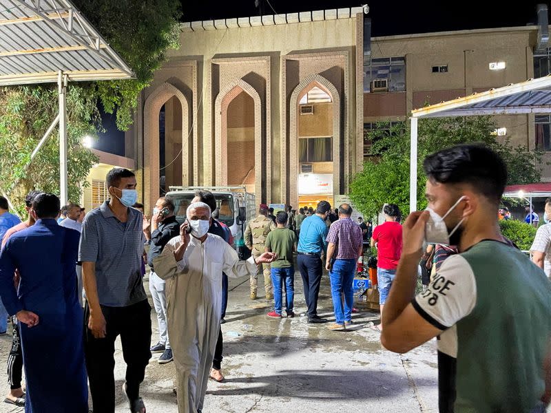 People gather inside Ibn Khatib hospital after a fire caused by an oxygen tank explosion in Baghdad