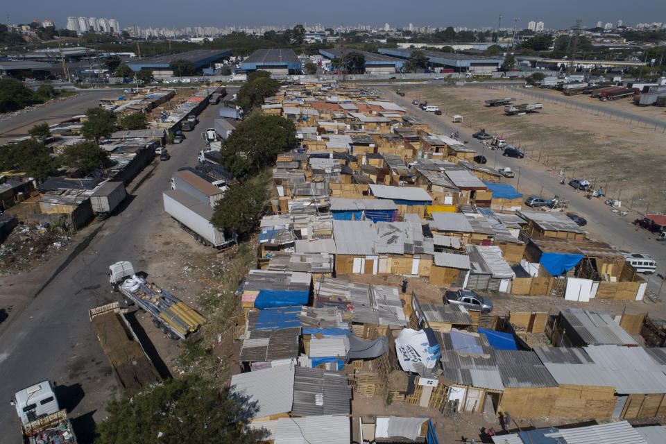 Shacks fill the Jardim Julieta squatter camp in Sao Paulo, Brazil, Thursday, July 23, 2020. The coronavirus had just hit the city when this parking lot for trucks became a favela, with dozens of shacks. Since the first wave of residents in mid-March, hundreds of families joined, with most having been evicted during the pandemic. (AP Photo/Andre Penner)