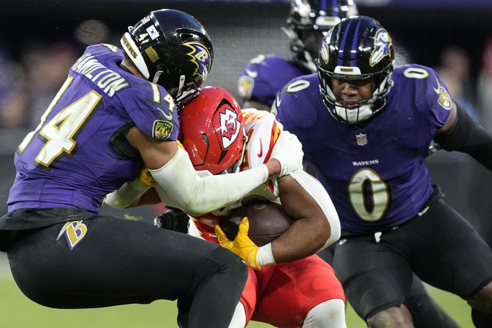 Kansas City Chiefs running back Clyde Edwards-Helaire (25) is hit by Baltimore Ravens safety Kyle Hamilton (14) during the second half of an AFC Championship NFL football game, Sunday, Jan. 28, 2024, in Baltimore. (AP Photo/Alex Brandon)
