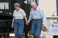 <p>Proving that age is nothing but a number, Rosalynn, then 80, and Jimmy, then 83, hold hands at the opening ceremony for the 2008 Carter Work Project in Biloxi, Mississippi.</p>