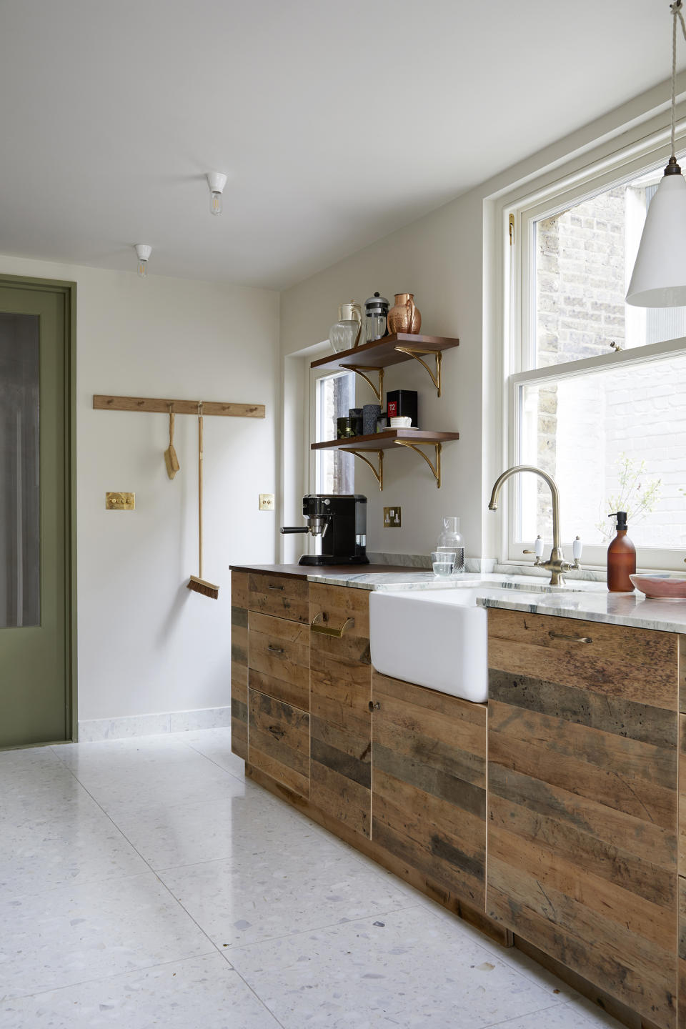 Kitchen with wood clad base cabinets and open wall shelves