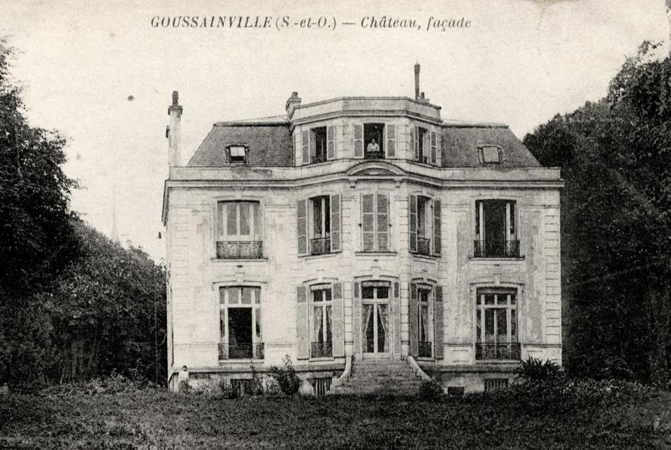 A vintage postcard printed in 1910 shows a grand 19th century manor with a woman looking out of a window from the top floor. (Reuters)