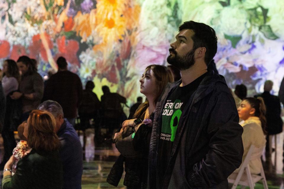 Kevin and Amanda Gilliland, of Oklahoma City, watch the "Immersive Van Gogh" exhibit Dec. 15 at the Oklahoma City Convention Center.