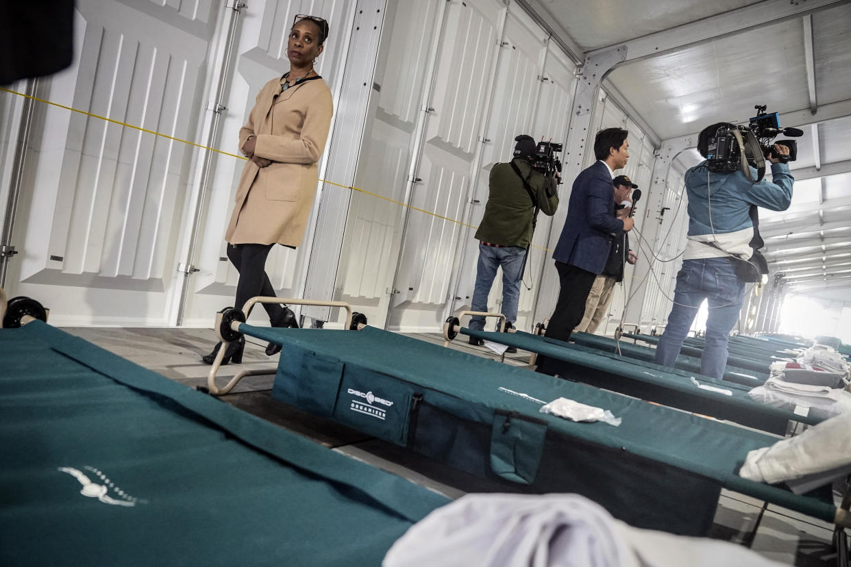 Deputy Mayor for Health and Human Services Anne Williams-Isom, left, tours the sleeping area of New York City's latest temporary shelter on Randall's Island for migrants being bused into the city by southern border states, Oct. 18, 2022, in New York. The shelter will start taking in single adult men on Wednesday, Oct. 19, with facilities including laundry, regular meals and access to international calls. (AP Photo/Bebeto Matthews)