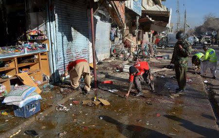 Rescue workers collect evidence from the site of a suicide bomb attack close to a polio eradication centre in Quetta, Pakistan, January 13, 2016. REUTERS/Stringer