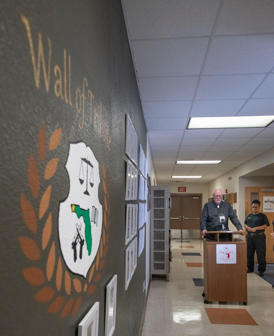 The Rev. Jim Duck, chaplain with the Pensacola Police Department, says a prayer during a ceremony dedicating the new Wall of Tribute to fallen law enforcement officers at the George Stone Criminal Justice Training Center in Pensacola on Tuesday.