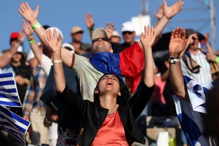 Christian pilgrims and tourists react during a religious retreat lead by T.B. Joshua, a Nigerian evangelical preacher on Mount Precipice, Nazareth