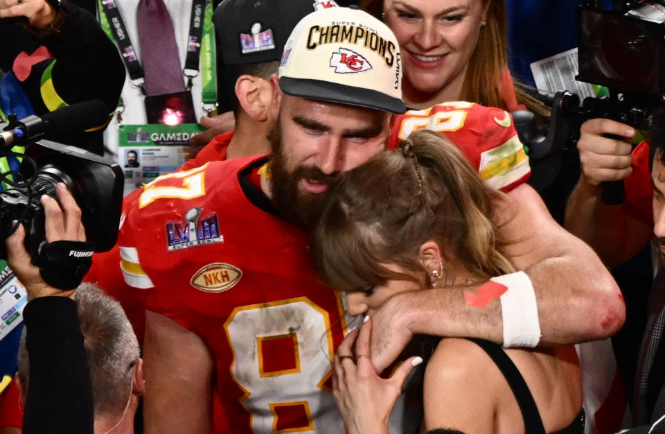 Taylor Swift and Kansas City Chiefs' tight end #87 Travis Kelce embrace after the Chiefs won Super Bowl LVIII