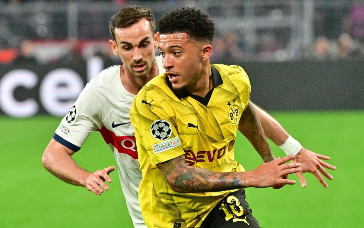 Jadon Sancho swerves past a PSG defender