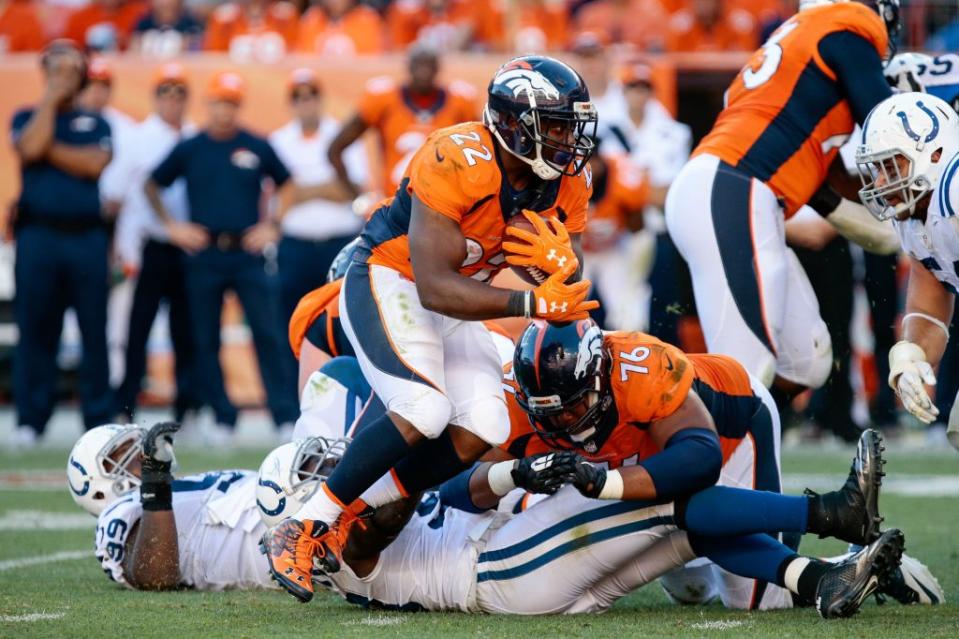 Sep 18, 2016; Denver, CO, USA; Denver Broncos running back C.J. Anderson (22) runs the ball as offensive guard Max Garcia (76) defends in the fourth quarter against the Indianapolis Colts at Sports Authority Field at Mile High. The Broncos won 34-20. Mandatory Credit: Isaiah J. Downing-USA TODAY Sports