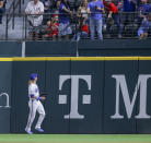 Texas Rangers right fielder Travis Jankowski, bottom, watches a Cincinnati Reds' Jonathan India two-run home run during the seventh inning of a baseball game in Arlington, Texas, Saturday, April 27, 2024. (AP Photo/Gareth Patterson)