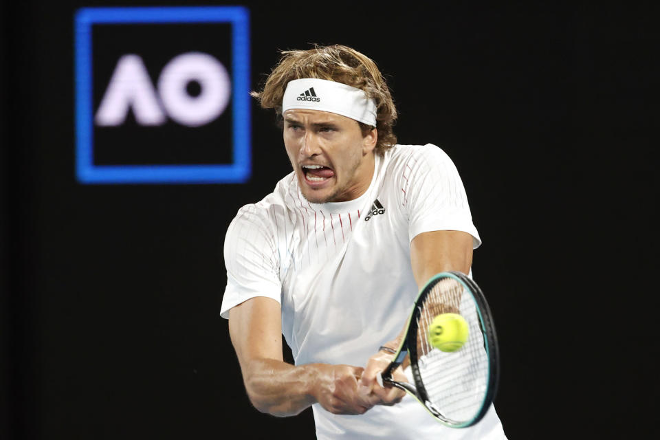Alexander Zverev of Germany plays a backhand return to compatriot Daniel Altmaier during their first round match at the Australian Open tennis championships in Melbourne, Australia, Monday, Jan. 17, 2022. (AP Photo/Hamish Blair)