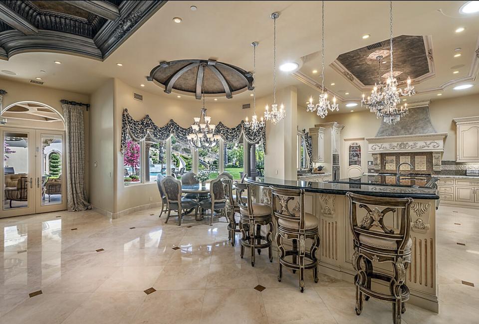 The 72 chandeliers is an exaggeration, but this photo of the large kitchen shows it has at least six