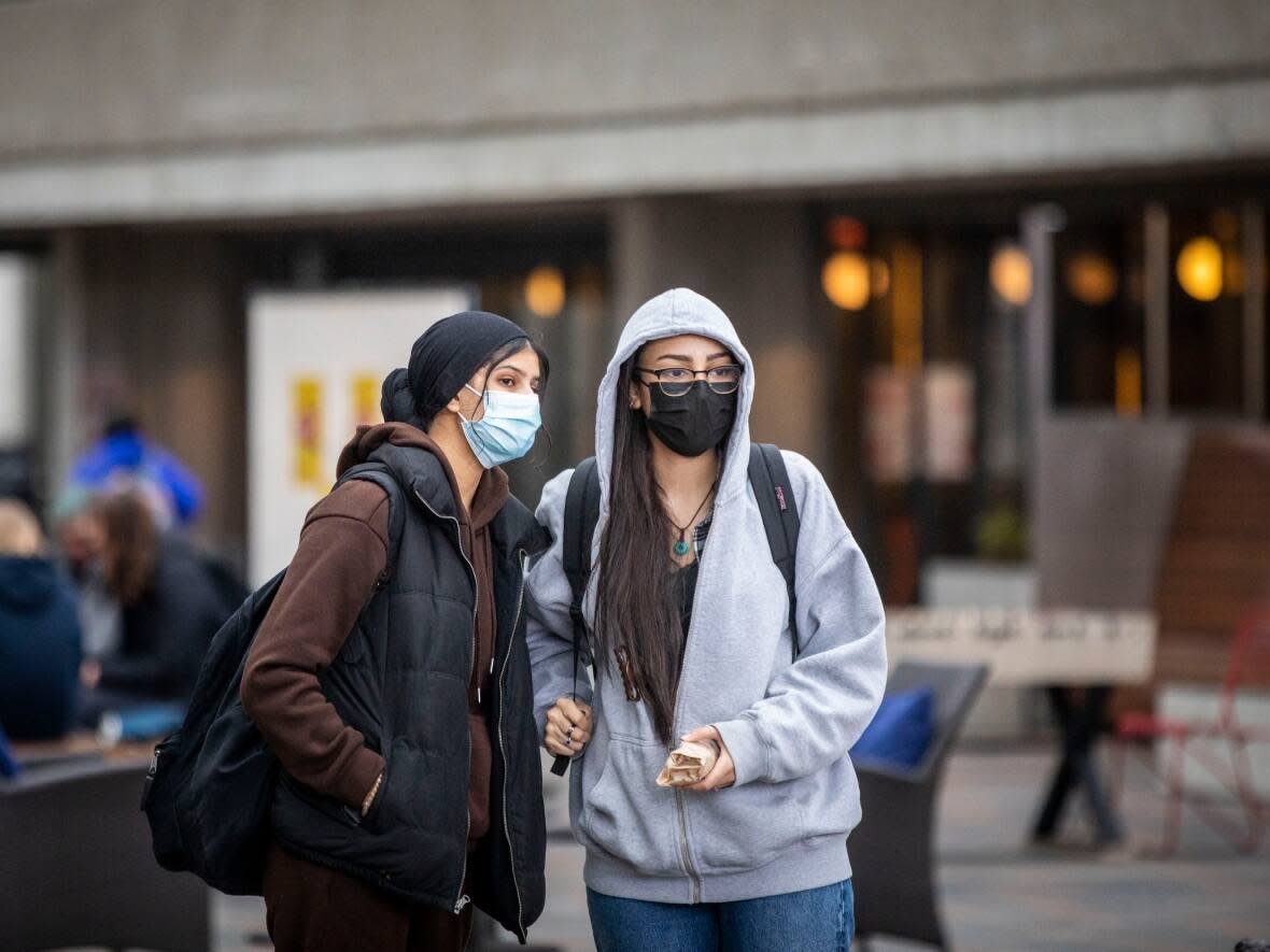 Simon Fraser University students are pictured on campus in Burnaby on March 23. New rules that went into effect Nov. 15 allow international students to work more than 20 hours a week while studying. (Ben Nelms/CBC - image credit)