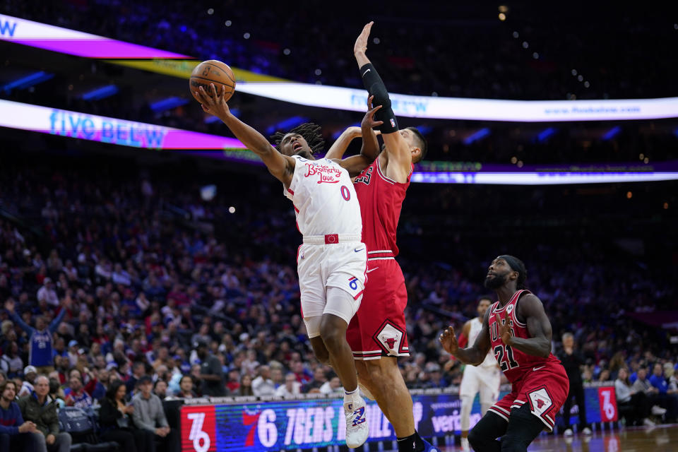 Philadelphia 76ers' Tyrese Maxey, left, goes up for a shot against Chicago Bulls' Nikola Vucevic during the second half of an NBA basketball game, Monday, March 20, 2023, in Philadelphia. (AP Photo/Matt Slocum)